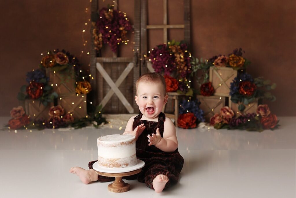 Messy cake smash portraits of baby girl in fall floral theme