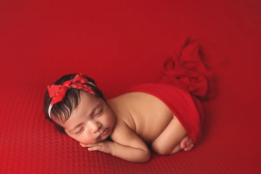 Kansas City newborn photographer luxury portrait of baby girl with bow