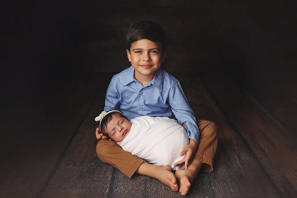 Luxury newborn portrait with baby girl and her older brother Kansas City
