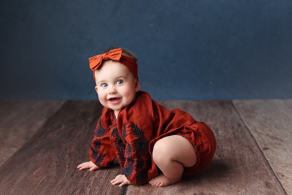Baby girl in fall floral themed portrait before cake smash session in Kansas City