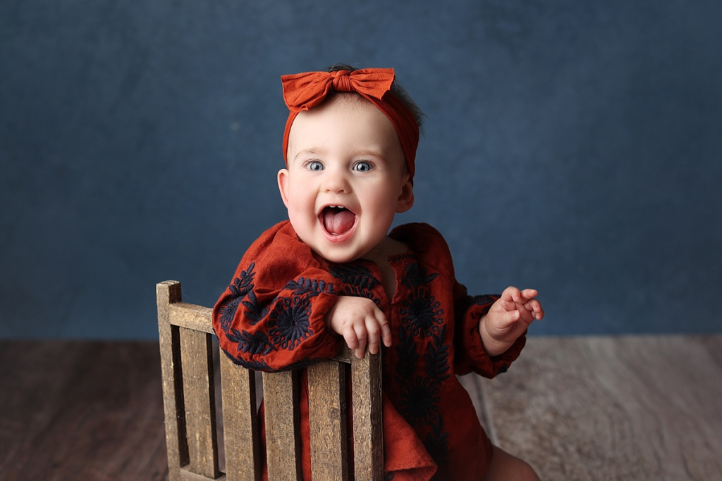 First birthday portraits of baby girl wearing floral outfit during professional session