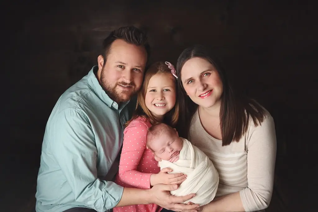 Family portrait with newborn baby boy, mom, dad, and big sister during professional Kansas City newborn photography session