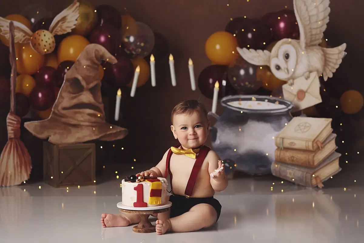 Baby boy with Hogwarts cake during Kansas City cake smash photography