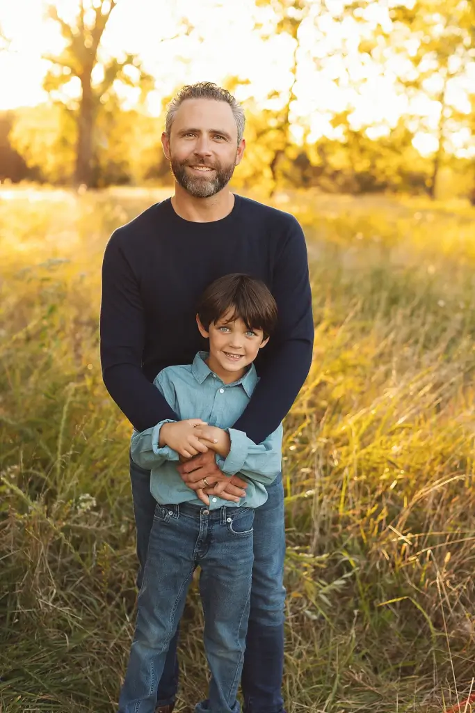 Father and son posing during fall family photography in Kansas City