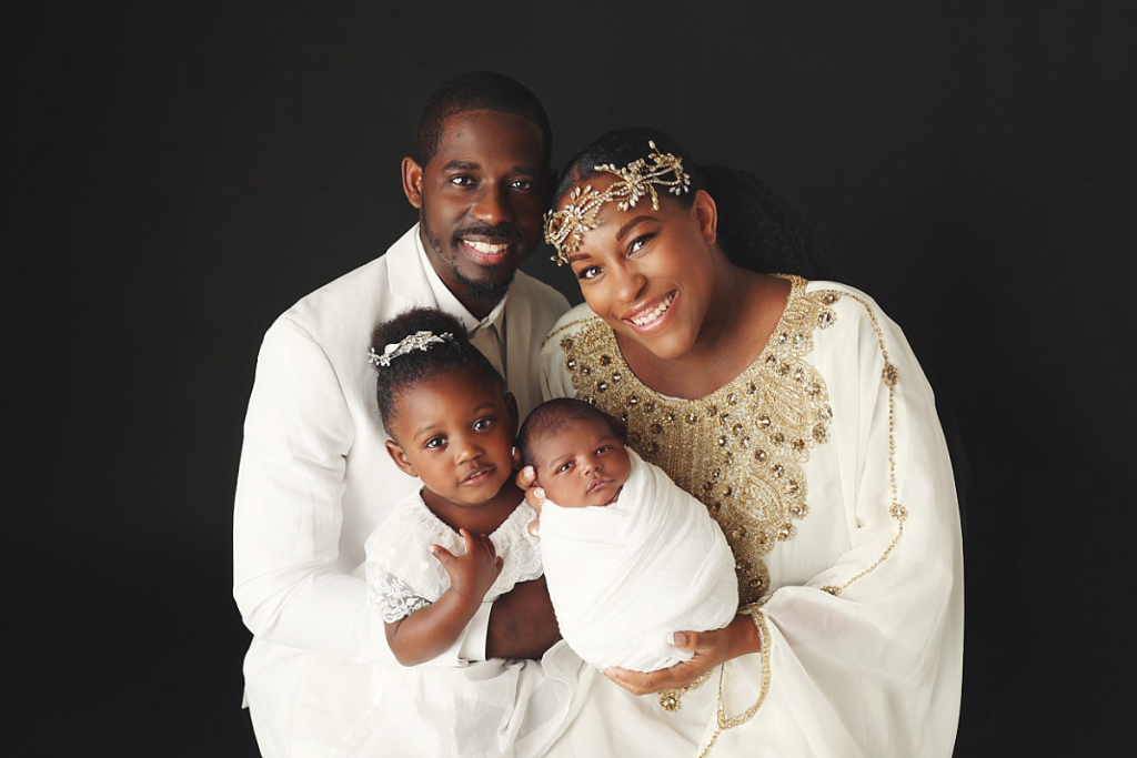 Family portrait with newborn baby boy, parents, and older sister in Kansas City newborn photography studio