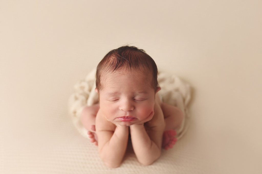 Sleeping newborn boy posed on soft blanket during Kansas City newborn photo session