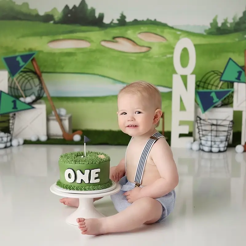 kansas-city-one-year-studio-session-golf-theme Baby boy celebrating first birthday with a golf themed cake smash session by Anna Marie Photography, testimonial from Amanda praising repeat sessions and lasting quality