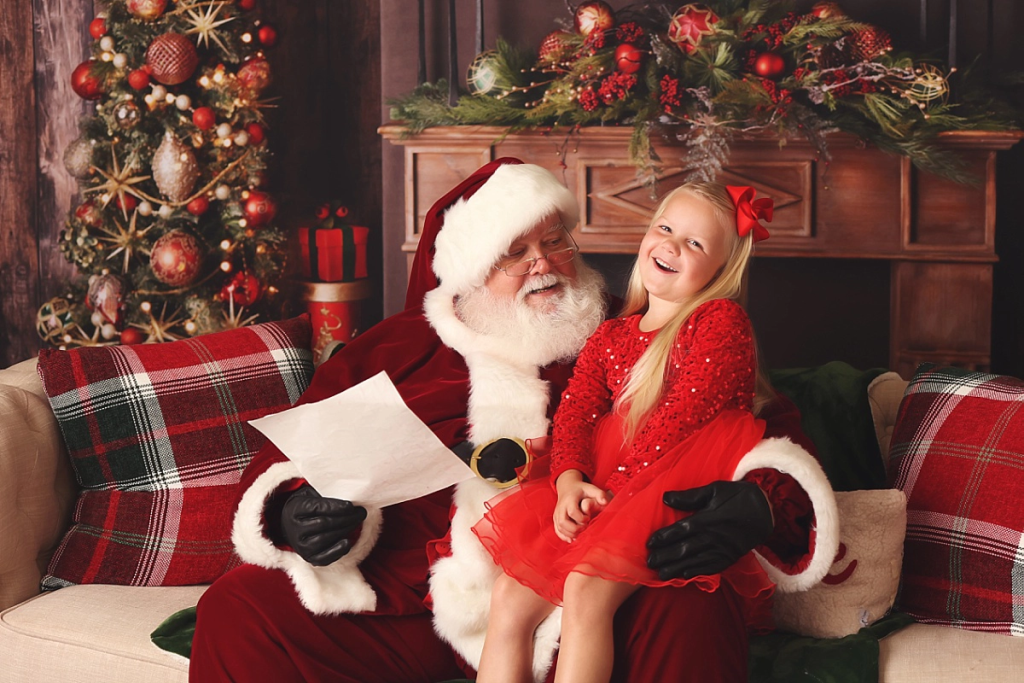 Little girl smiling with Santa during Kansas City holiday photo session