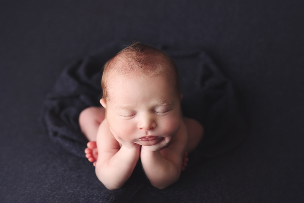 Baby boy in froggy pose during safe Kansas City newborn photography session