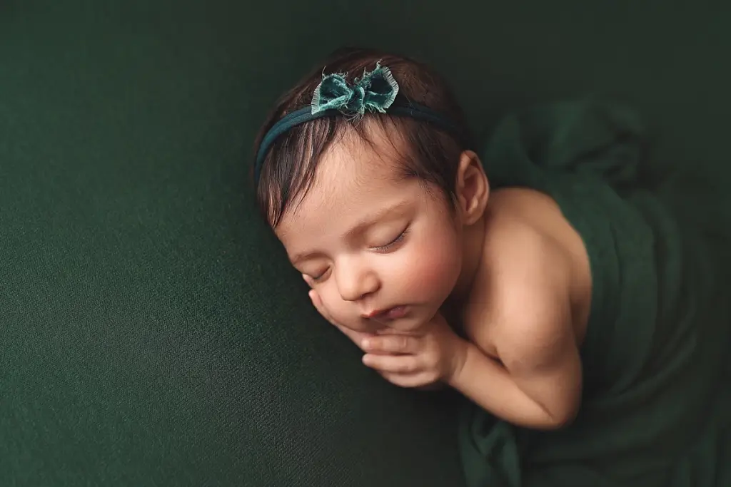 Fine art newborn image of baby girl with floral headband Kansas City