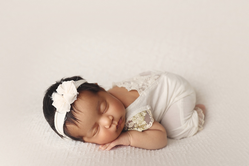 Baby girl posed on textured blanket during stress-free newborn photography experience in Kansas City