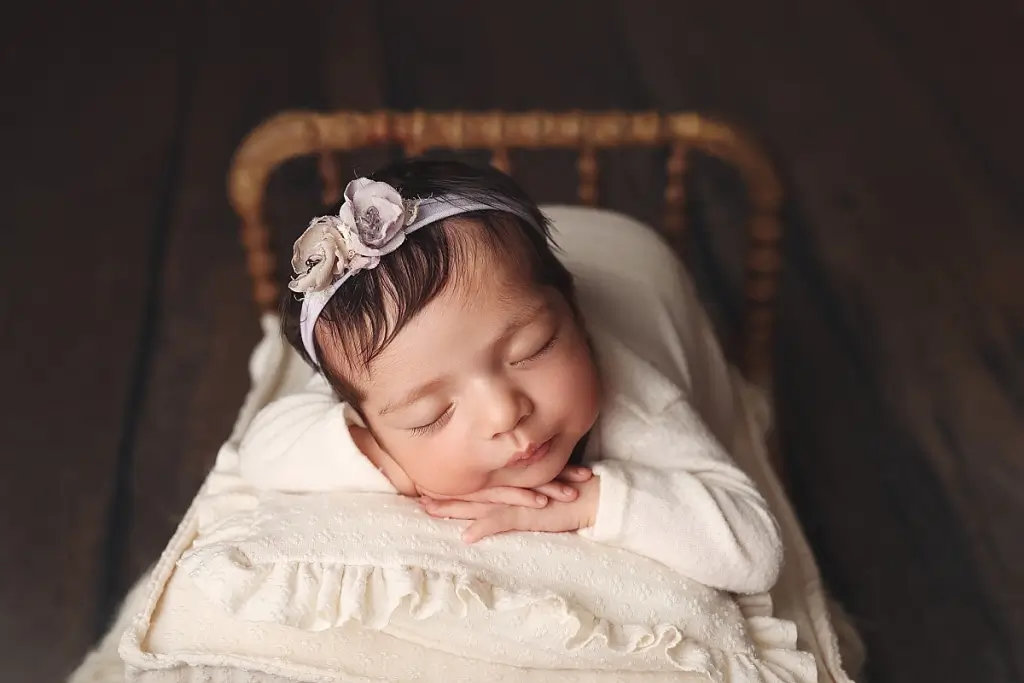Kansas City newborn photographer luxury portrait of baby girl with bow