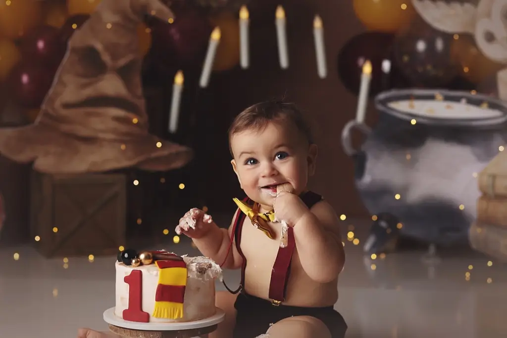 First birthday portraits with Harry Potter props and themed cake in Kansas City