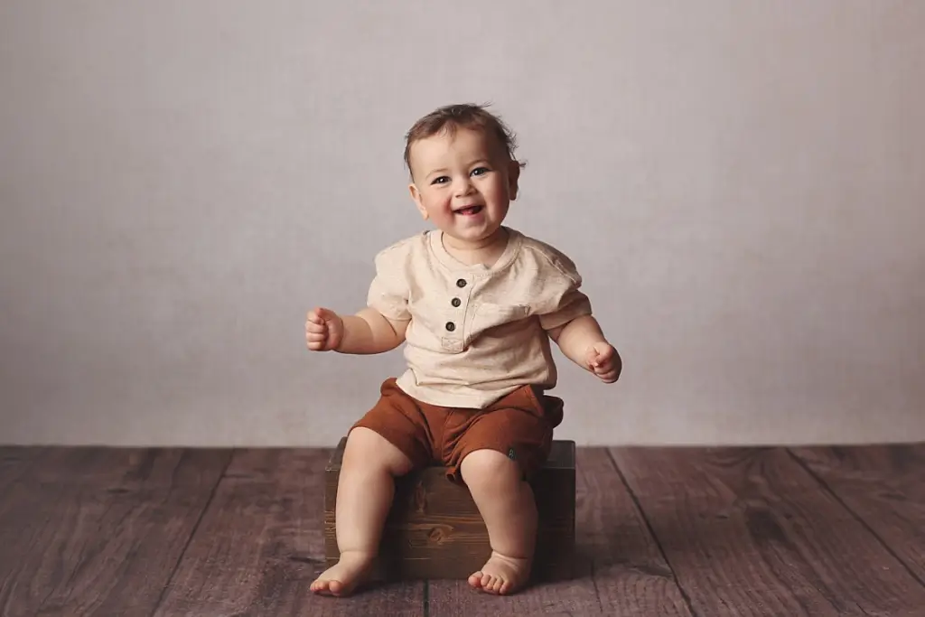 Baby boy smiling during professional first birthday photo session in Kansas City
