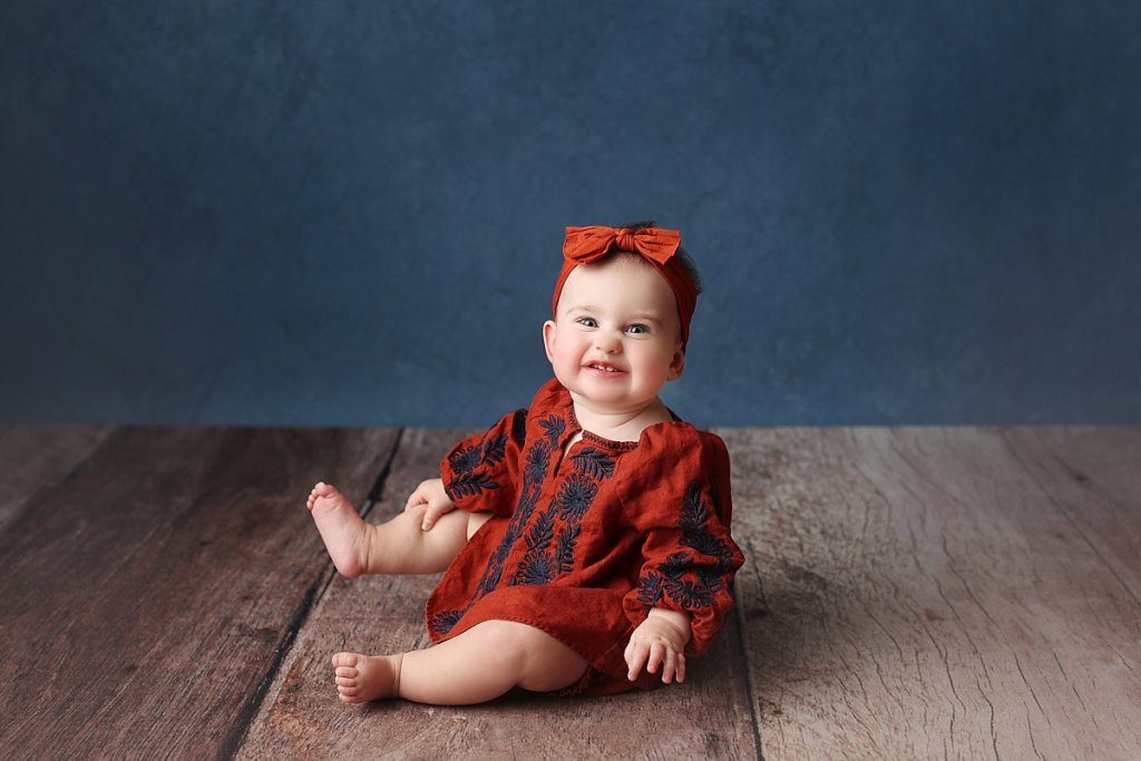 First birthday portraits of baby girl wearing floral outfit during professional session