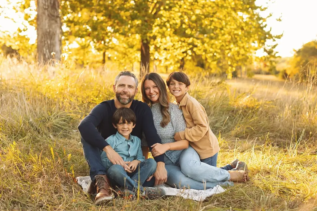 Parents smiling with two boys during Kansas City fall family portraits