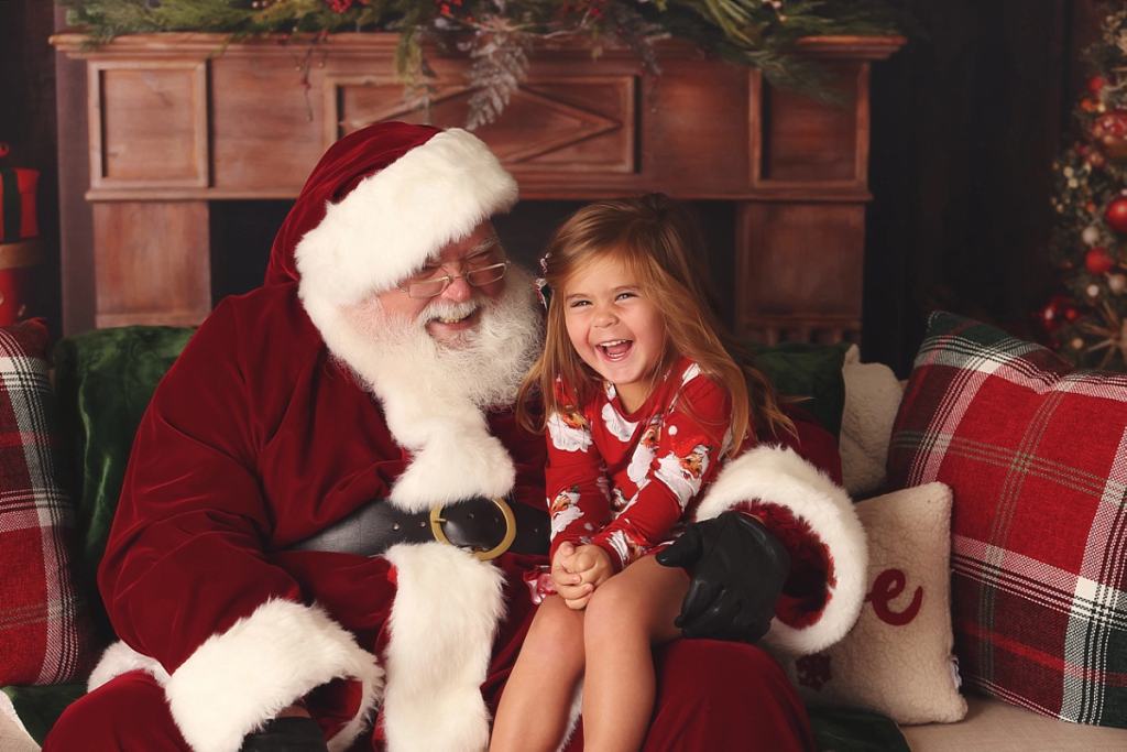Child laughing with Santa Claus during stress-free Santa session Kansas City