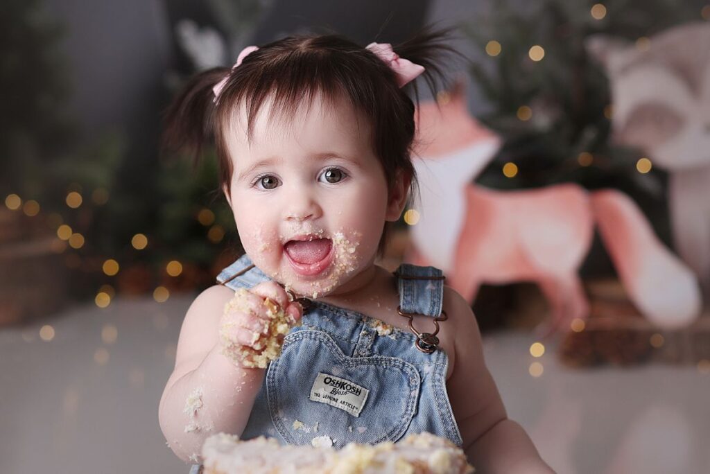 close up of little girl with pigtails at kansas city cake smash