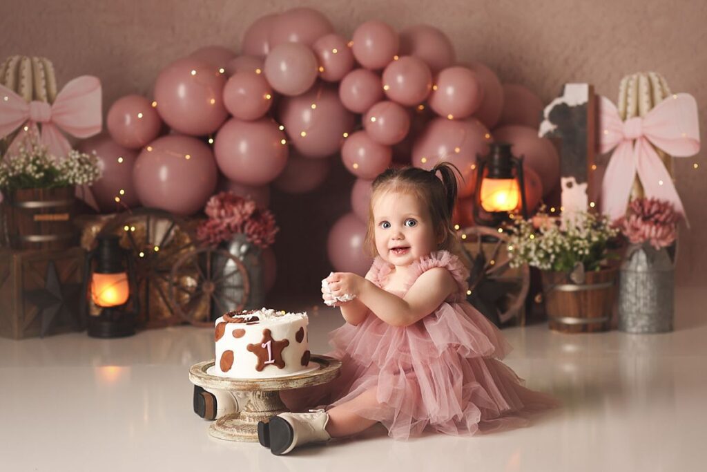 pink western cake smash for one year old girl at kansas city photography studio
