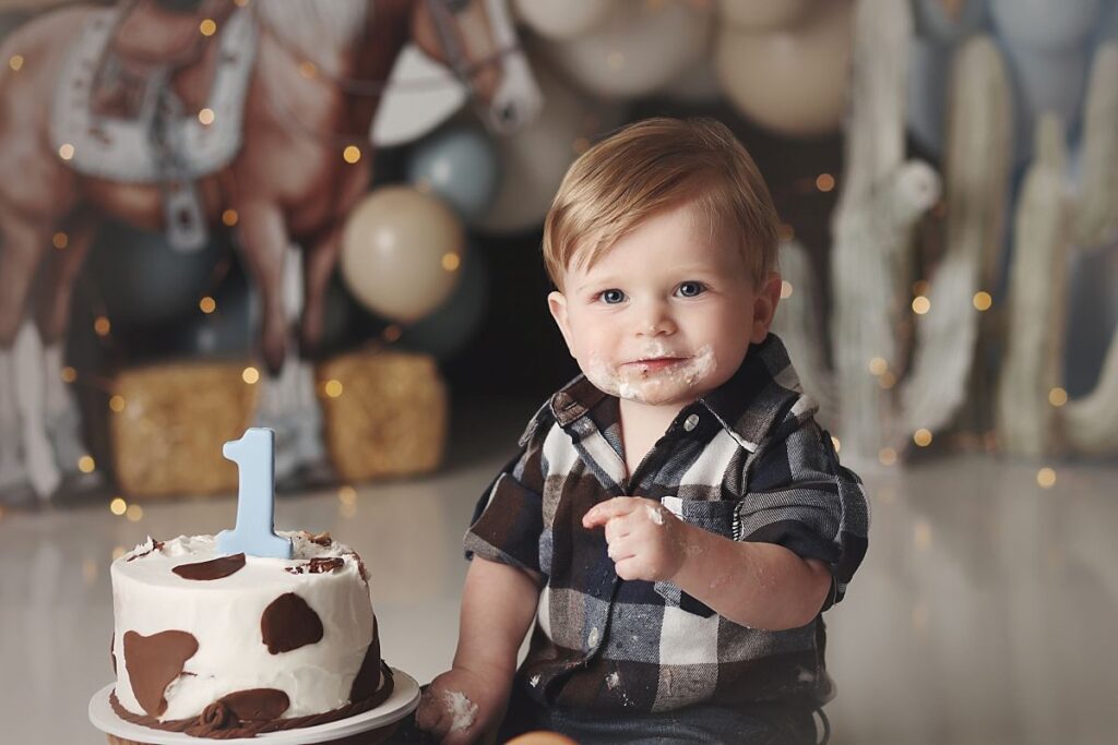 blue and brown themed western cake smash close up of one year old boy in kansas city cake smash studio