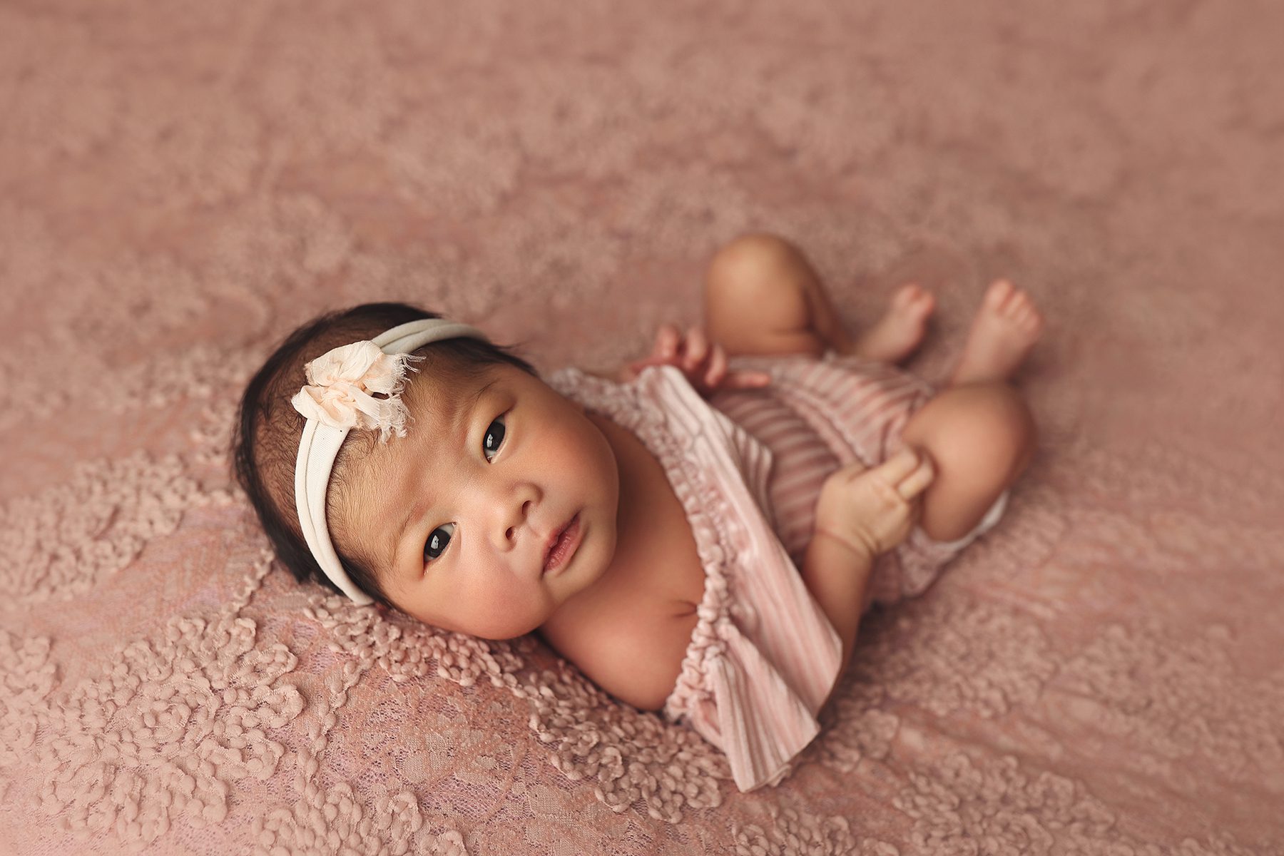 Kansas City newborn photography studio session with awake baby girl on a lace blanket