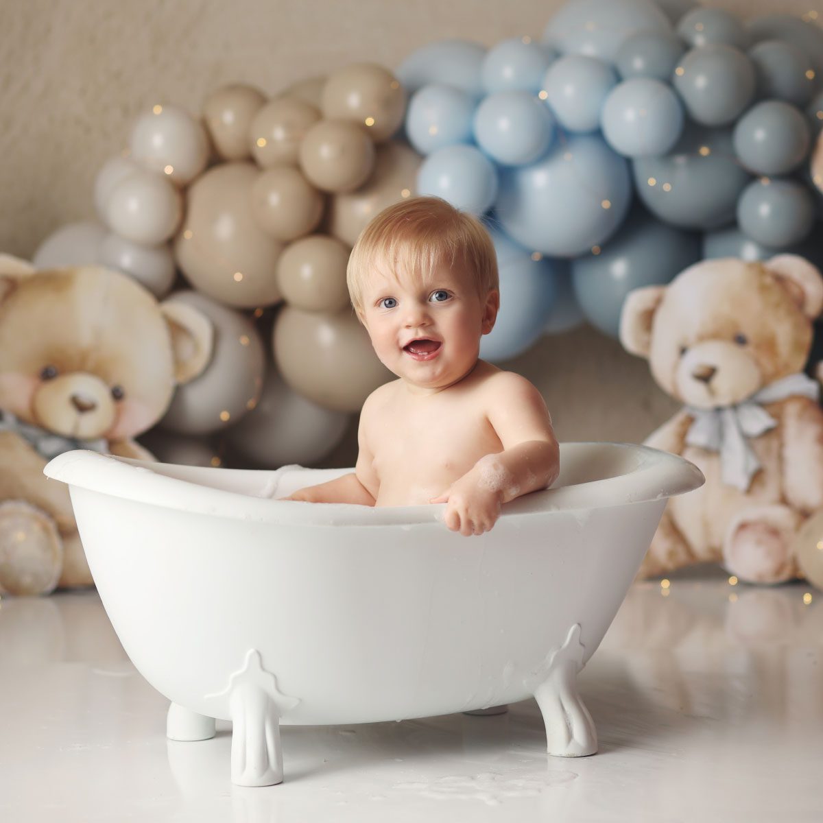 Little boy in bath splash after teddy bear themed cake smash in Kansas City studio