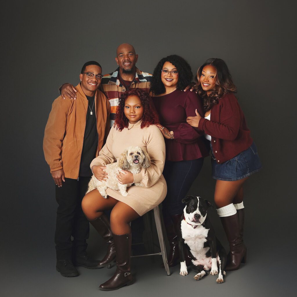 Family with teenage twins, younger daughter, and two dogs photographed in studio