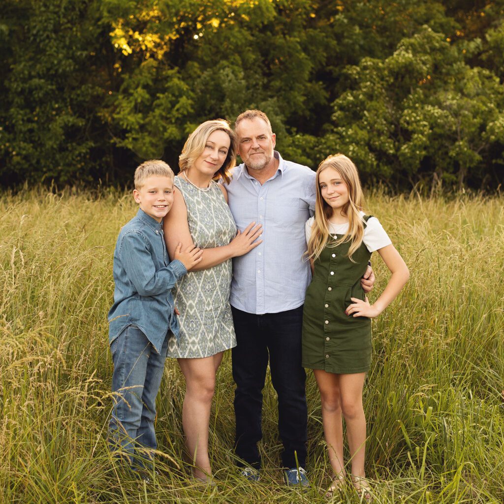 Family with preteen twins photographed during a family summer session