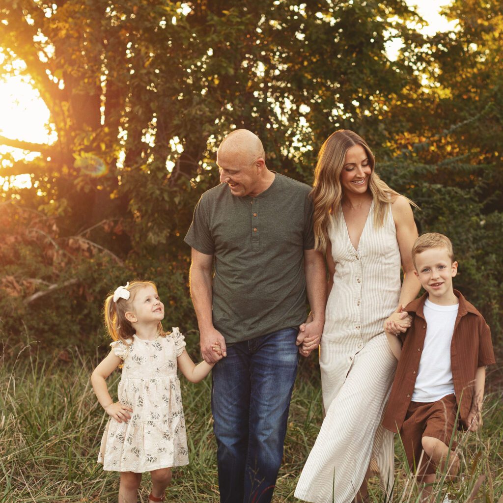 Family walking together at sunset during an outdoor session